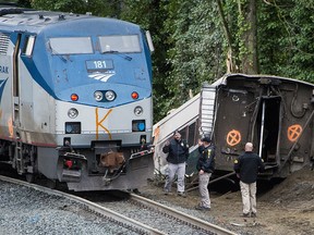 Emergency crews respond after an Amtrak train that derailed Monday, Dec. 18, 2017, in DuPont, Wash. The Amtrak train making the first-ever run along a faster new route hurtled off the overpass Monday near Tacoma and spilled some of its cars onto the highway below, killing several people, authorities said.