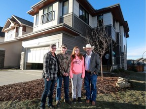 Gary and Marnie Wakelam and their children Hunter and Evie stand outside their new Calgary Stampede Rotary Dream Home by Homes by Avi in Carrington.