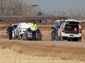 RCMP officers investigate at the scene of a suspicious death east of Calgary near Township Road 232 and Range Road 282 on Wednesday December 6, 2017. Gavin Young/Postmedia