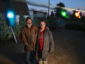Kelly Johnsen and his wife Mary Anne help run a charity Christmas Tree lot along 50th avenue near Elbow Drive. S.W. They were photographed in the lot at dusk on Wednesday December 13, 2017.