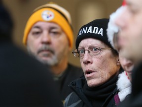 Midfield Park residents Mark Dufor and Lori Sperling listen as their lawyer Mathew Farrell speaks with reporters outside council chambers on Monday.