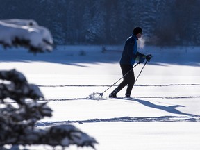 A cross-country skier takes advantage of fresh snow for a cross-country ski in Glenmore Park.