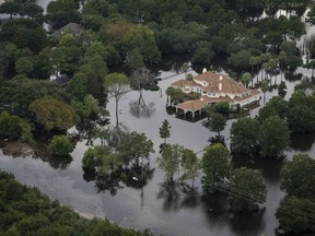 Floodwaters are seen surrounding houses and apartment complexes in West Houston, Texas, on Aug 30. Hurricane Harvey pushed thousands of people to rooftops or higher ground as they had to flee their homes. MUST CREDIT: Washington Post photo by Jabin Botsford