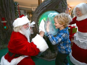 Harrison Markin, 6 yrs, experiences a giant snow globe and visits Santa and Mrs Claus at Southcentre Mall in southwest Calgary on  Sunday, December 3, 2017. The mall hosted a before-opening hours sensory-friendly Christmas/Santa event designed for children with autism, mobility disabilities and other special needs. Jim Wells/Postmedia