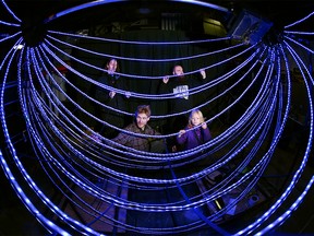 Stephen Burak, Greg Maciejewski, Danny Glavin and Stephen's daughter Lucia, 5 yrs, work on the new New Year's Eve Ball (sponsored by Downtown Calgary)  in Calgary on Friday, December 29, 2017. The 10' around ball, built in sections and then assembled on site, will  be lit by 16,000+ multi colored LED lights and weighs 263 pounds and will be lowered 30ft during City of Calgary celebrations on New Year's Eve. Jim Wells/Postmedia