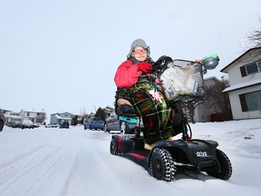 Lori-Ann Ellis, who must rely on a scooter to get around, demonstrates how easily she gets stuck in a couple inches of snow near her Aberdare Rd NE Calgary street on Friday, December 29, 2017. Ellis must use her scooter on the road as there is no sidewalk in front of her house, but unless the roads are plowed or packed flat, she gets stuck and is unable to navigate in her community. Jim Wells/Postmedia