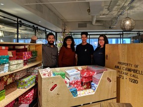 Christmas boxes full of such items as mitts, scarves, hats, soap and tooth brushes will be delivered shortly.  From left are Michael Tandara and Shavonne Doell of Dream Unlimited and Ben Campbell and Krista O’Neill of AMJ Campbell which donated time and vehicles to help deliver the packages.