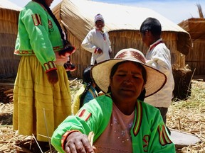 A Uro-Aymara woman shows how the ladies cook on the floating Uros islands.