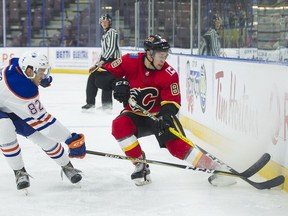 Edmonton Oilers Caleb Jones tries to check Calgary Flames Andrew Mangiapane during the NHL Young Stars Classic hockey action at the South Okanagan Events Centre in Penticton, BC, September, 8, 2017.