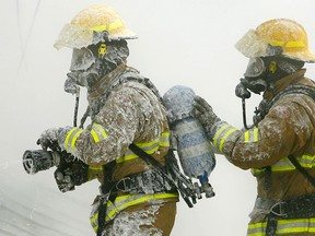 Firefighters battle a garage fire in the southeast community of Penbrooke in January, 2009.