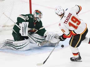 Minnesota Wild's goalie Alex Stalock blocks the goal attempt by Calgary Flames' Matthew Tkachuk in a shootout during an NHL hockey game Tuesday, Dec. 12, 2017, in St. Paul, Minn. The Wild won 2-1 in the shootout.