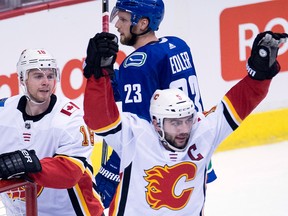 Calgary Flames defenceman Mark Giordano (No. 5) celebrates his goal against the Vancouver Canucks during second period NHL action in Vancouver, Sunday, Dec. 17, 2017.