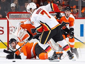 Sean Couturier of the Philadelphia Flyers drops to block a pass from T.J. Brodie of the Calgary Flames at the Wells Fargo Center on Nov. 18, 2017 in Philadelphia.