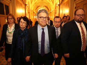 Sen. Al Franken (D-MN) (C) and his wife Franni Bryson (L) arrive at the U.S. Capitol Building December 7, 2017 in Washington, DC. Franken announced that he will be resigning in the coming weeks after being accused by several women of sexual harrassment.