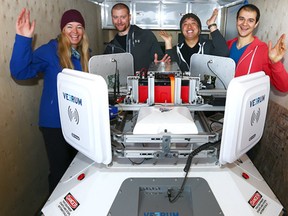 (L-R) Kristy Dixon, Zac Trolley, Maxwell Lee and Adam Bhavnani pose with their oilfiled robot at the opeing of Fuse33 MakerSpace on Radisson Dr in southeast Calgary on Friday, December 1, 2017. FUSE33 offers an array of educational classes, and monthly memberships that provide Calgarians with access to state-of-the-art equipment, including: a wood shop, tool library, electronics lab, metal shop, 3D printers, sewing lab, and laser cutters. Jim Wells/Postmedia