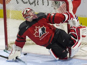Team Canada goalie Carter Hart makes a save during a 9-0 pre-tournament victory over Team Czech Republic at Budweiser Gardens in London, Ont. on Dec. 20, 2017.