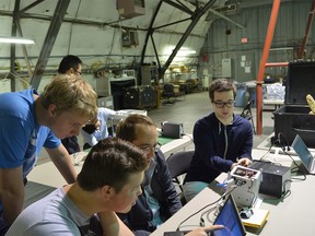 Adam Ursenbach, Addison Lindemann, advisor Matthew Patrick and Benjamin Wolfman, part of the high school team which participated in NASA's High Altitude Student Platform program, prepare their solar panel project at the NASA Columbia Scientific Balloon Facility in Ft. Sumner, New Mexico in September.