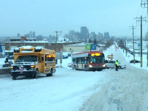 A city bus struggles to negotiate a slippery hill as police direct traffic on Centre Avenue N.E. Wednesday morning.