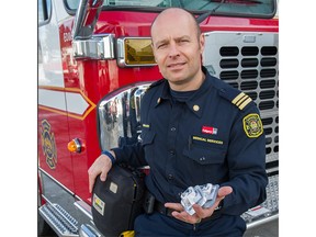 Firefighter Gordon Toothe, Medical Services Coordinator with Calgary Fire Department holds a handful of Narcan nasal spray. Photo courtesy of the Calgary Fire Department