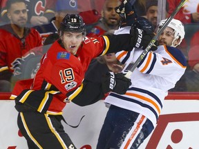 Flames Matthew Tkachuk (L) mixes it up with Oilers Kris Russell during NHL action between the Edmonton OIlers and the Calgary Flames in Calgary Saturday, December 2, 2017. Photo by Jim Wells/Postmedia