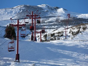 The old red chair at Castle Mountain takes skiers to the summit. Credit: Andrew Penner