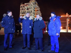 From the left, Russian Energy Minister Alexander Novak, Novatek's CEO Leonid Mikhelson, and Russian President Vladimir Putin, visit Liquified Natural Gas plant Yamal LNG in the port of Sabetta on the Yamal peninsula beyond the Arctic circle, in Sabetta, Russia, Friday, Dec. 8, 2017. Putin launched Friday a $27 billion liquefied natural gas plant in Siberian Arctic as Russia hopes to surpass Qatar to become the world's biggest exporter of the chilled fuel.