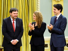 Prime Minister Justin Trudeau and Governor General Julie Payette applaud after Richard Wagner, left, is sworn in on Dec. 18 as the new Chief Justice of Canada.