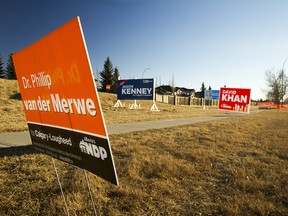 Campaign signs line a street in the community of Woodlands in Calgary-Lougheed. A byelection will be held in the riding on Dec. 14, 2017.