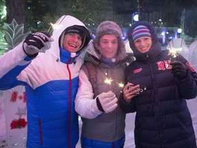 Make Mikhailov, Egor Anufriev and Katya Stolyarova pose with sparklers lit while passing through Olympic Plaza on New Year's Eve, Sunday, Dec. 31, 2017 in Calgary, Alta. The City of Calgary cancelled a series of outdoor events planned for New Year’s Eve at Olympic Plaza due to temperatures hovering around -28 C, but the plans for a countdown ball and fireworks show are still on for midnight.