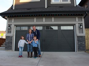 For caption reference, names are Wayne Thompson, Claire Thompson, and the little girl is Georgie (7), and boy is Jack (5). Christmas bank story on home ownership for immigrants, through various programs including Jayman Built Story and photos by Joel Griffith For Calgary Herald