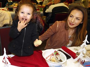 Larissa Starlight and her daughter, Araya,18 months, attend the annual Tsuut'ina Nation Christmas Feast and Procession at the Grey Eagle Event Centre on Dec. 28, 2017.