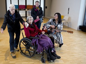 Dorothy Phillips, 84, left, and Marie Bredo, 87, enjoy the music of music therapist Sara Pun, right,  plays at the National Music Centre in Calgary, on Wednesday January 31, 2018, during their event exploring the healing power of music. Leah Hennel/Postmedia