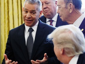 TransCanada CEO Russ Girling speaks to President Donald Trump in the Oval Office of the White House in Washington, Friday, March 24, 2017, during an announcement on the approval of a permit to build the Keystone XL pipeline, clearing the way for the $8 billion project.