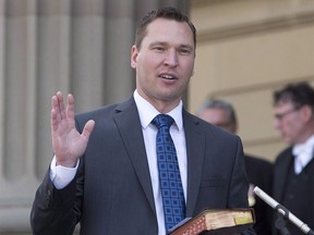 Alberta says it will formally take action on two fronts Thursday in its escalating fight with Saskatchewan over the ban on Alberta licence plates on Saskatchewan jobsites. Deron Bilous is sworn in as the Alberta Minister of Municipal Affairs, Service Alberta in Edmonton on Sunday, May 24, 2015. THE CANADIAN PRESS/Jason Franson ORG XMIT: CPT141