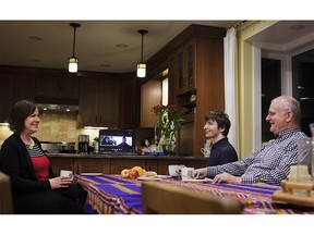 Judy Arnall and her jet-setting family members often spend time together through video conference call. She was interviewed for a Family Day weekend story about 21st-century parenting. Pictured from left is Judy, Heidi (on screen), Marlin (on screen), Scott, and Peter Arnall. KERIANNE SPROULE/POSTMEDIA