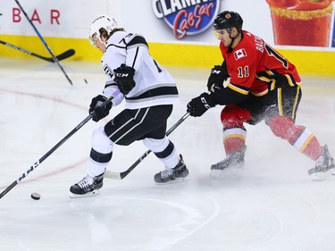 Calgary Flames' Mikael Backlund and the LA Kings' Tyler Toffoli duel for the puck during NHL action in Calgary on Wednesday January 24, 2018.