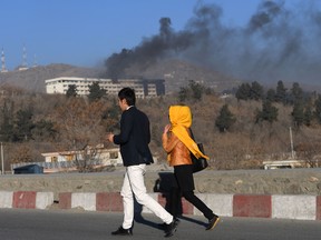 Smoke billows during a fight between gunmen and Afghan security forces at the Intercontinental Hotel in Kabul on January 21, 2018.