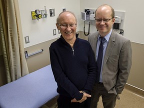 ALS patient Cliff Barr, left, who is taking part in a new Canada-wide clinical trial to treat ALS, poses in an examination room with tria leader Dr. Lawrence Korngut, in Calgary, Alta., Thursday, Jan. 4, 2018. THE CANADIAN PRESS/Jeff McIntosh ORG XMIT: JMC102