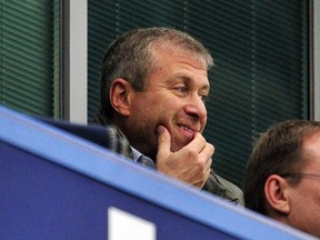 Roman Abramovich takes his seat before the English Premier League soccer match between Chelsea and Fulham at Stamford Bridge in London on September 21, 2013.