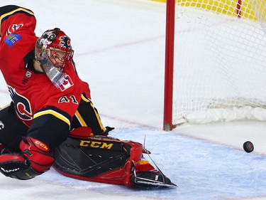 Calgary Flames goaltender Mike Smith looks back anxiously as the puck ricochets off the post during NHL action against the Los Angeles Kings on Wednesday January 24, 2018.