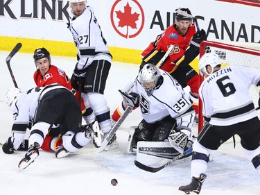 Los Angeles Kings goaltender Darcy Kuemper scrambles along with teammates and the Calgary Flames as the puck bounces in front of the Kings net during NHL action in Calgary on Wednesday January 24, 2018.