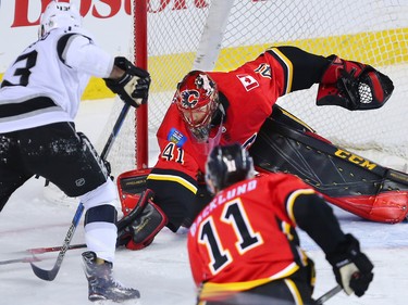 Calgary Flames goaltender Mike Smith stops the Los Angeles Kings' Kyle Clifford during NHL action in Calgary on Wednesday January 24, 2018.