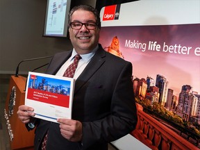 Calgary Mayor Naheed Nenshi holds a copy of the City's annual Citizen Satisfaction Survey on Monday, Jan. 28, 2018