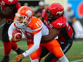 BC Lions quarterback Jonathon Jennings is sacked by the Calgary Stampeders' Ja'Gared Davis during CFL action at McMahon Stadium in Calgary on Saturday September 16, 2017. Gavin Young/Postmedia
