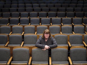 Vicki Stroich, Alberta Theatre Projects executive director, sits in an empty theatre in Calgary. The city's performing arts scene has become a casualty of corporate cost cutting as economic doldrums drag into their third year.