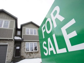 A for sale sign is shown outside a house under construction in a new subdivision in Beckwith, Ont., on Wednesday, Jan. 11, 2018. The Canadian Real Estate Assocation says national home sales rose 4.5 per cent in December from the month before. THE CANADIAN PRESS/Sean Kilpatrick