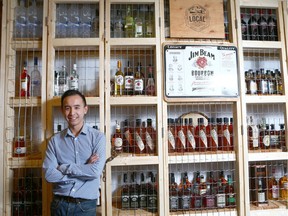 James Nguyen (GM) poses in front of the 'whisky wall' at Belle Southern Kitchen and Bar on 4 St SW in Calgary Thursday, January 4, 2018.