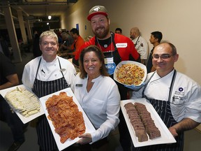 L-R, Darren Swift, Chef of the Hyatt Regency, Carlene Donnelly, CUPS Executive Director, Spencer Wilson, Calgary Stampeders Offensive Lineman and David Flegel, Executive Chef of the Hyatt Regency Calgary were on hand as CUPS celebrated ìChristmas in Januaryî for those in need in Calgary on Tuesday January 16, 2018. Darren Makowichuk/Postmedia