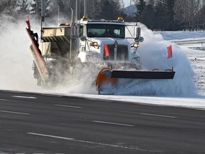 A plow clears a dusting of snow in a file photo.