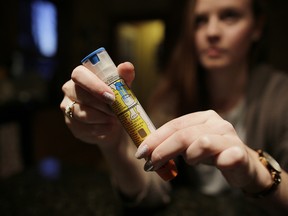 Kate Henderson, who has a peanut allergy, handles her EpiPen in her Ottawa home on Jan. 6, 2017.